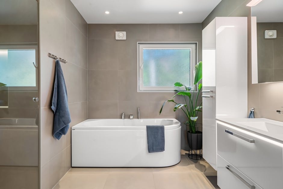 Bright bathroom scene with ventilation and neatly arranged towels